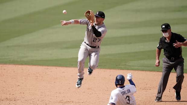 Aug 23, 2020; Los Angeles, California, USA; Los Angeles Dodgers left fielder Chris Taylor (3) slides into second base to beat a throw to Colorado Rockies shortstop Trevor Story (27) for a stolen base in the seventh inning at Dodger Stadium. Mandatory Credit: Kirby Lee-USA TODAY Sports